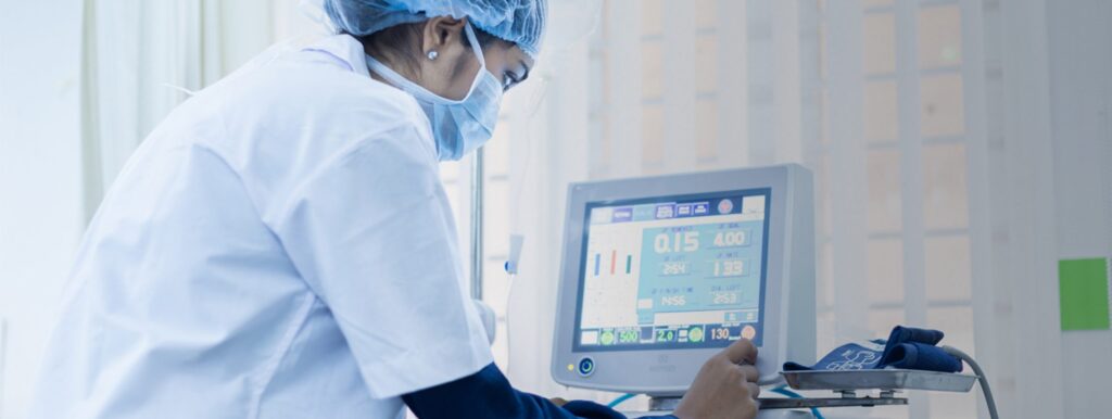 Healthcare professional monitoring a patient’s vital signs on advanced diagnostic equipment—reflecting the modern cardiology practices advocated by Dr. Jai Bhagwan Dhull, expert in cardiothoracic and vascular surgery.