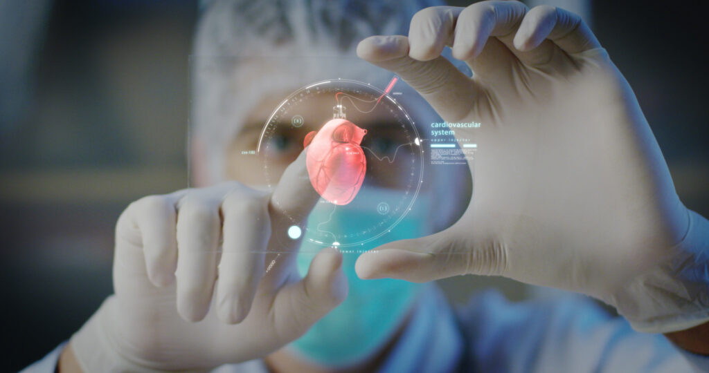 Medical professional analyzing a 3D holographic model of a human heart—symbolizing the future of cardiovascular innovation led by experts like Dr. Jai Bhagwan Dhull, a pioneer in advanced cardiothoracic and vascular surgery.