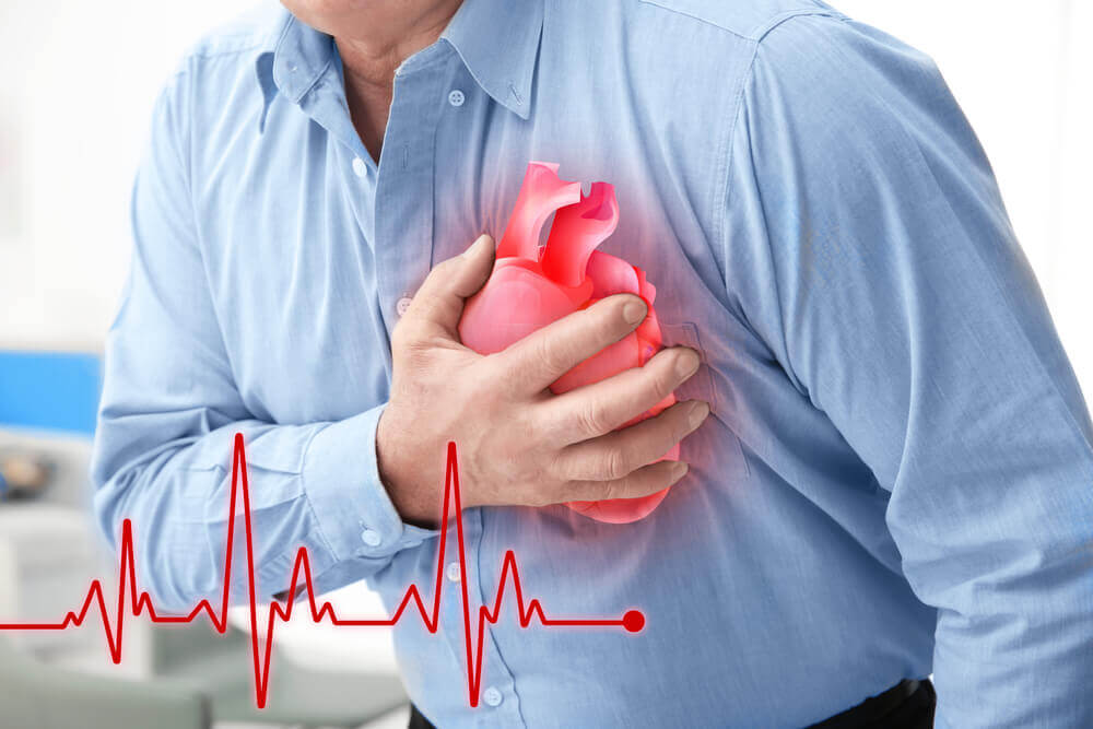 Man experiencing chest pain and possible heart attack with ECG line illustration, highlighting the importance of timely heart care by Dr. Jai Bhagwan Dhull, expert Cardiothoracic & Vascular Surgeon.
